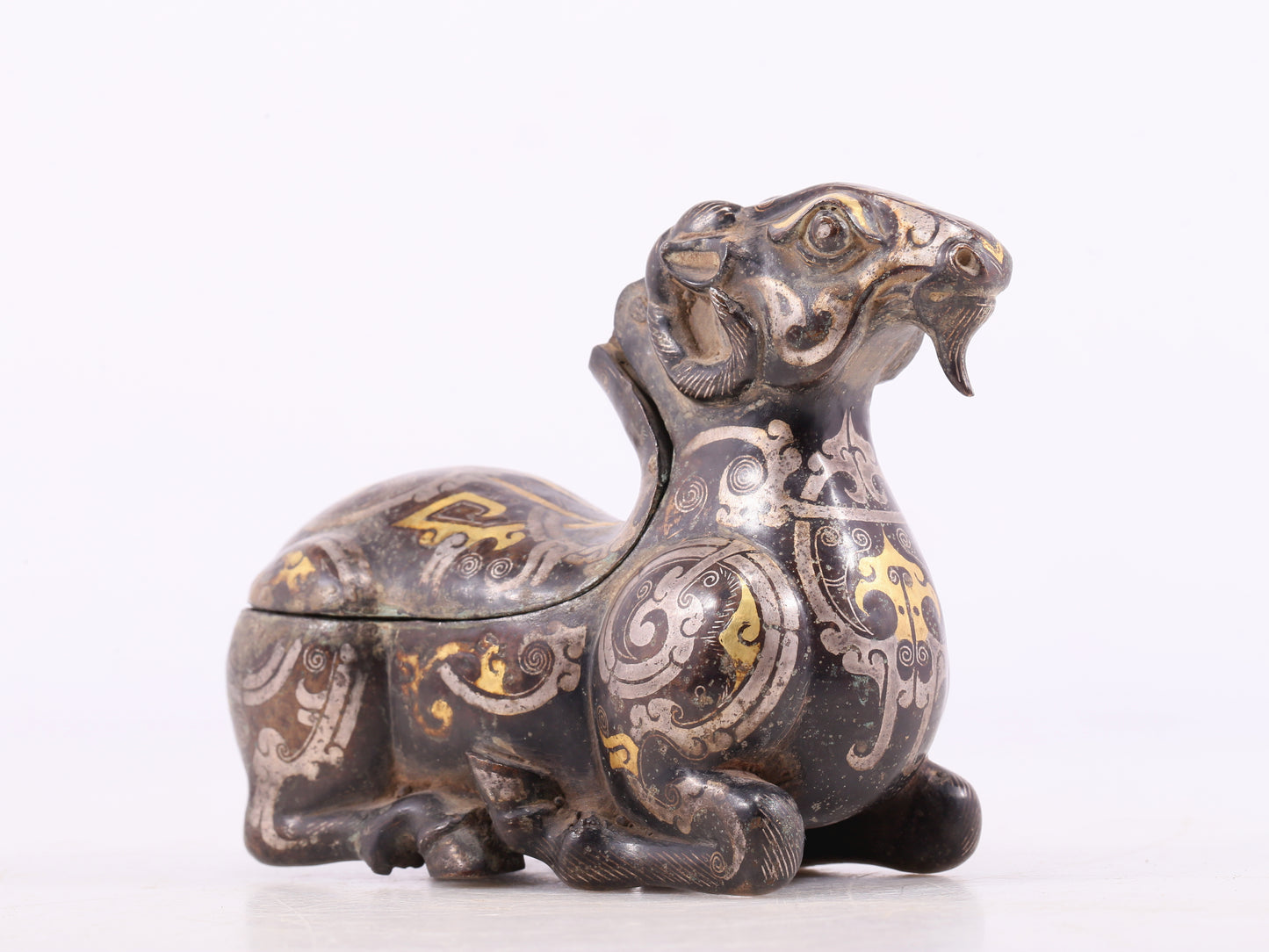 An Archaic Bronze Gold& Silver-Mounted Ram-Form Candlestick