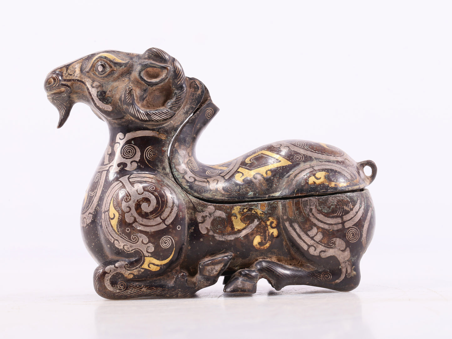 An Archaic Bronze Gold& Silver-Mounted Ram-Form Candlestick