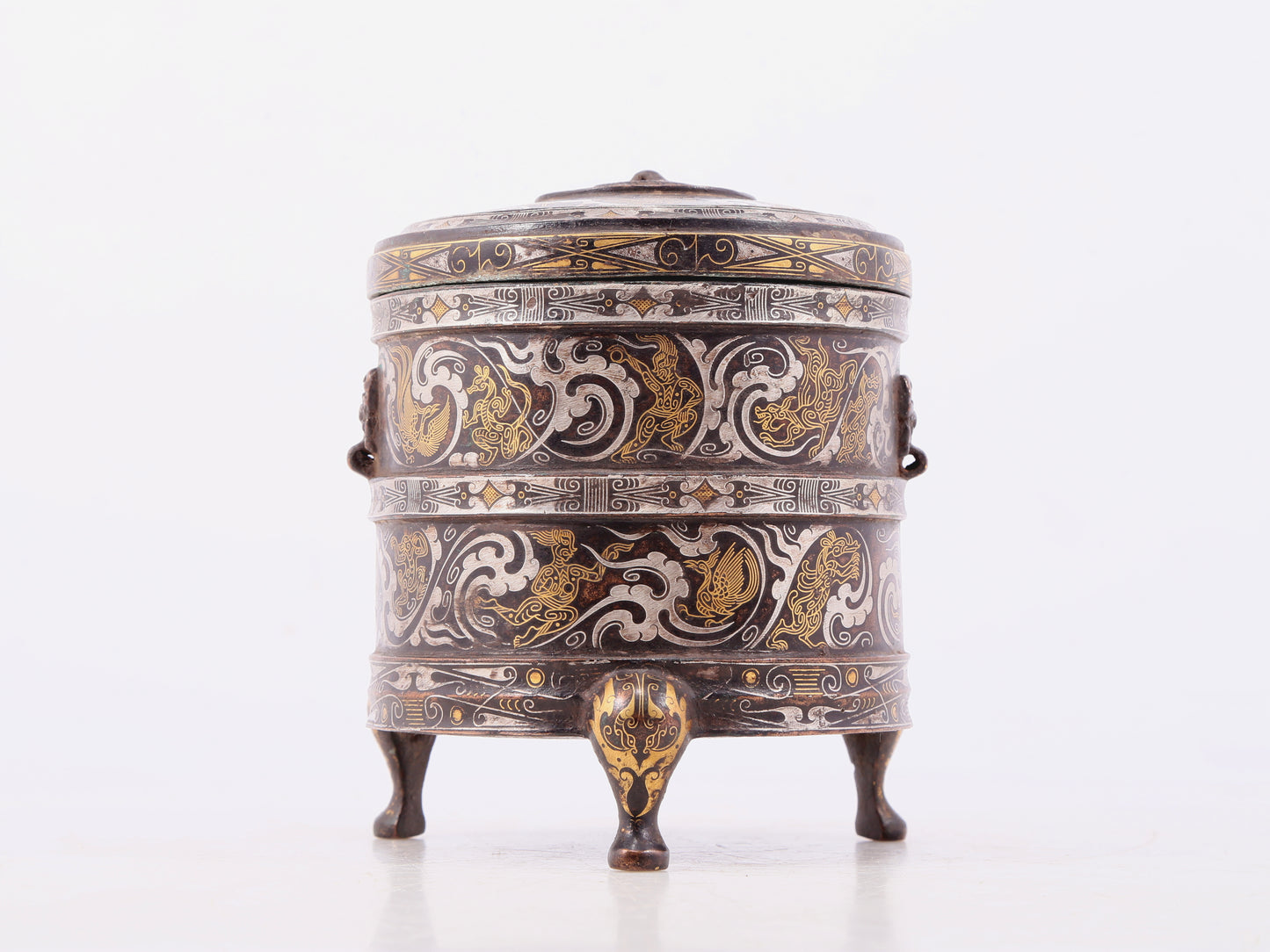 An exquisite bronze inlaid gold and silver tripod jar with auspicious clouds and animal patterns with lid