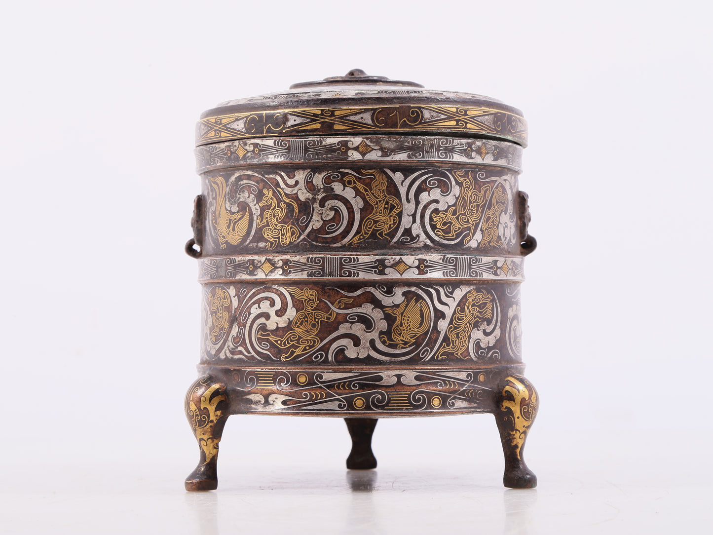 An exquisite bronze inlaid gold and silver tripod jar with auspicious clouds and animal patterns with lid