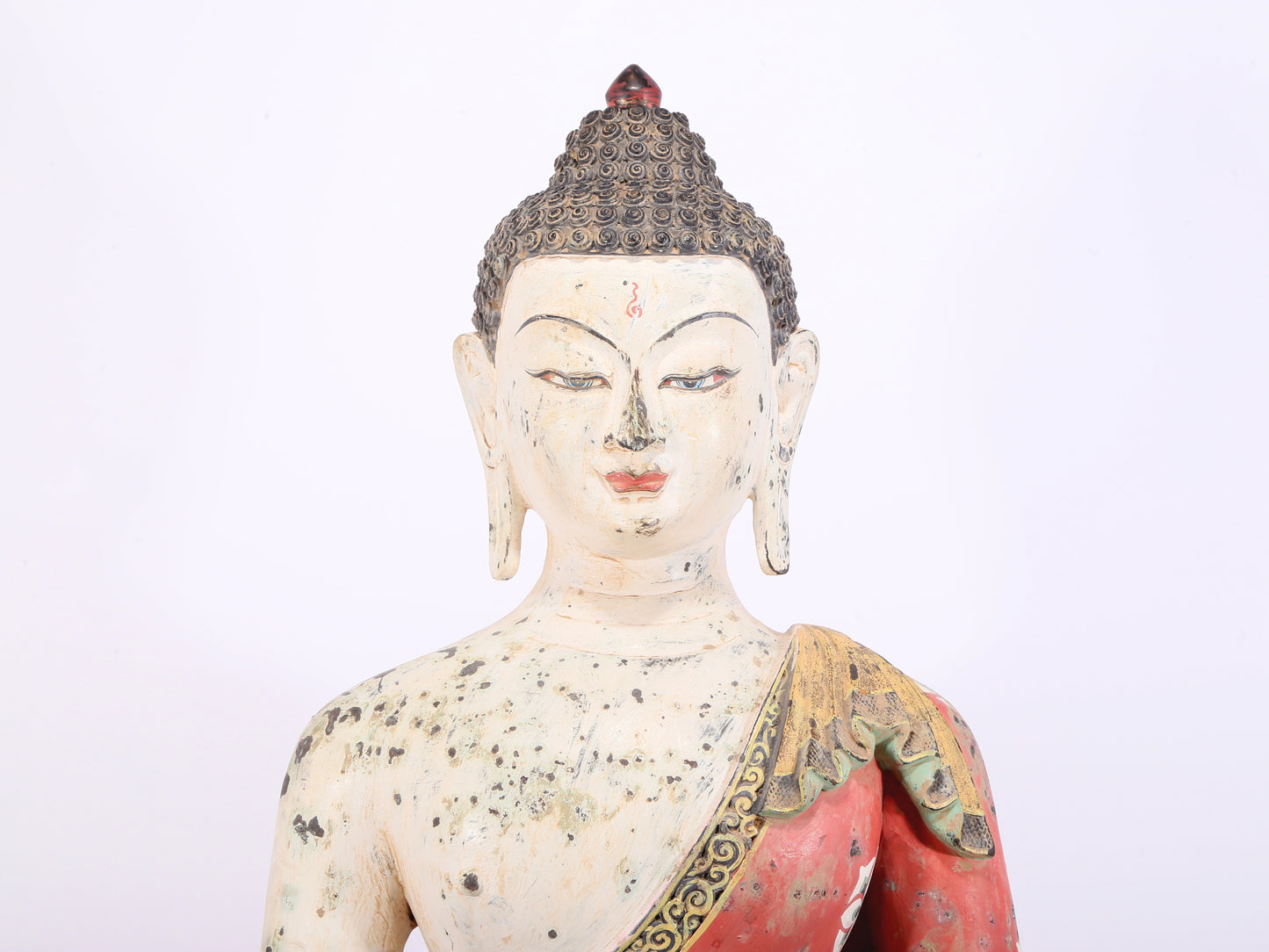 A solemn bronze painted statue of Gautama Buddha