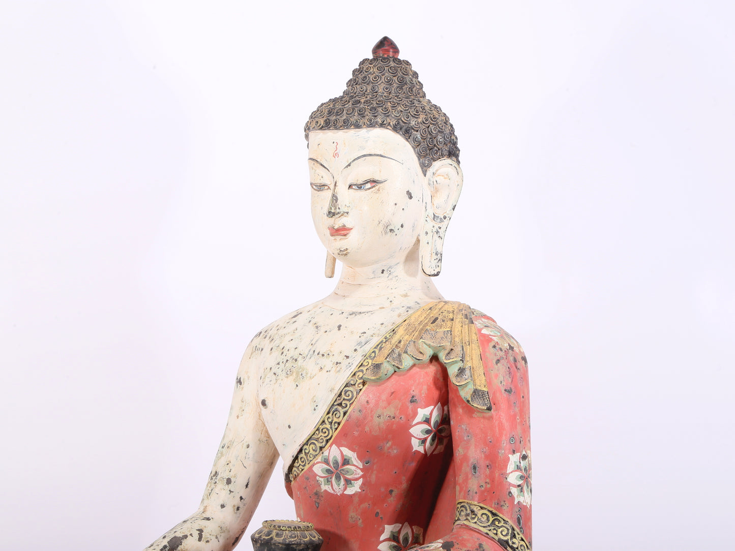 A solemn bronze painted statue of Gautama Buddha