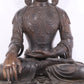 A solemn bronze Buddha statue