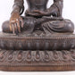 A solemn bronze Buddha statue