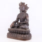 A solemn bronze Buddha statue