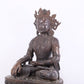 A solemn bronze Buddha statue