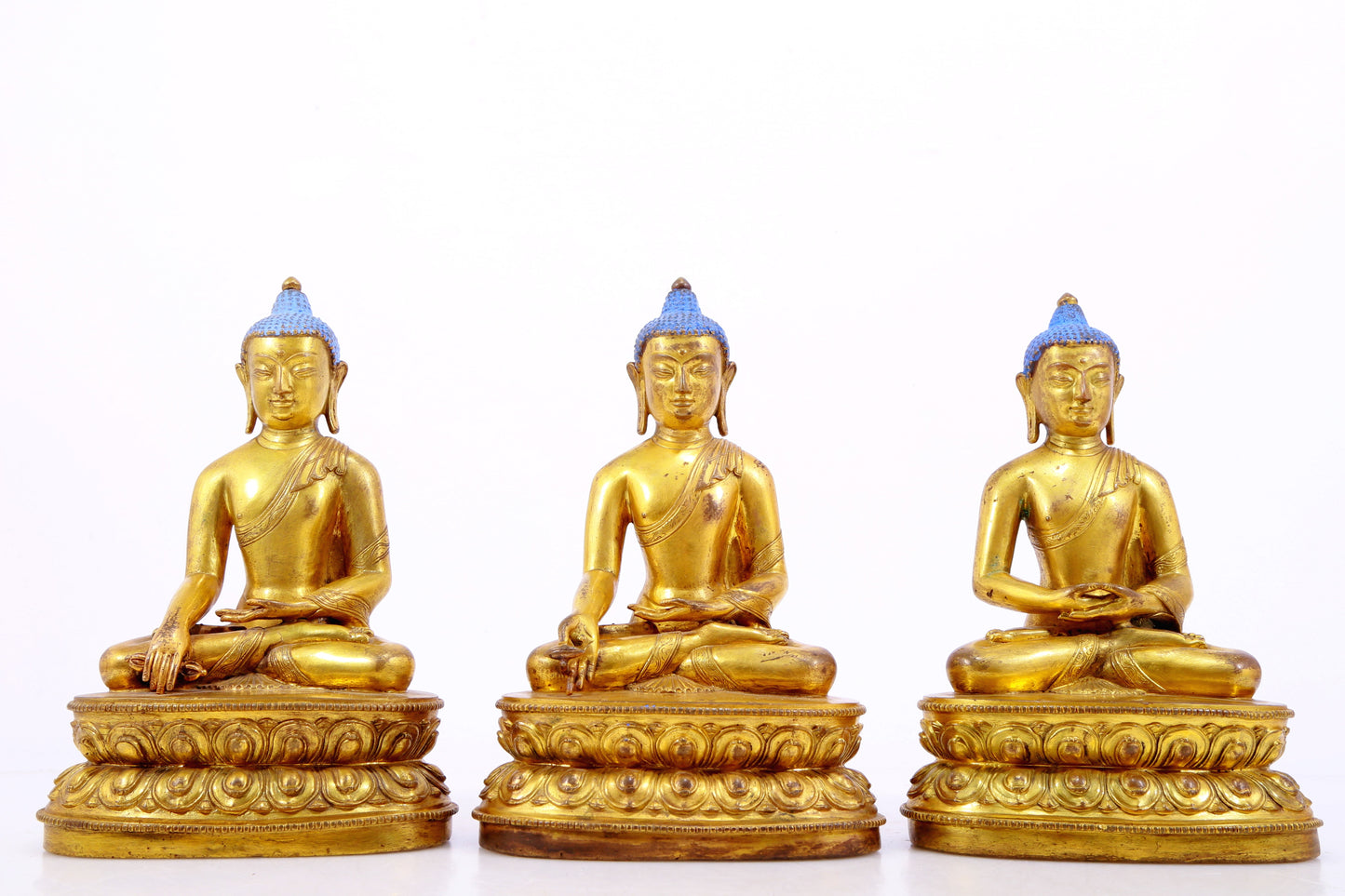 A Magnificent Set Of Three Gilt-Bronze Figures Of Buddha