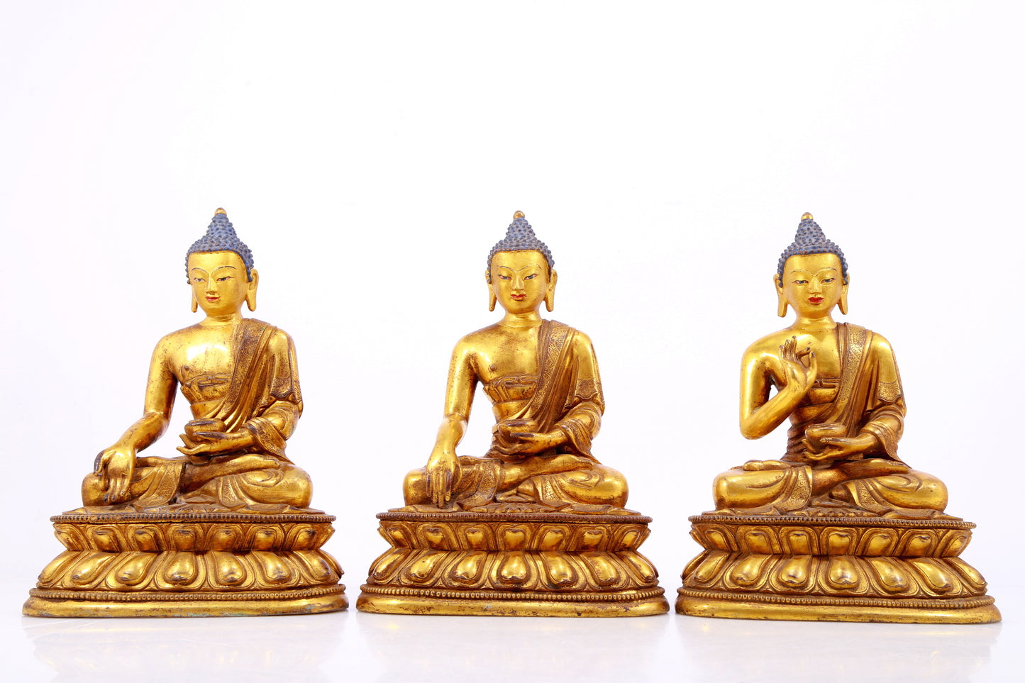 A Magnificent Set Of Three Gilt-Bronze Figures Of Buddha Shakyamuni