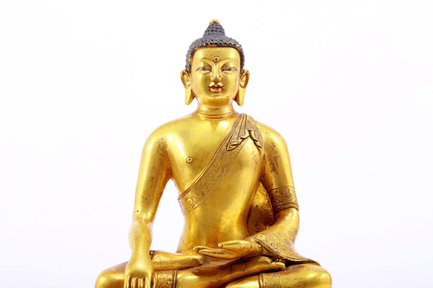 A gilt bronze statue of Gautama Buddha