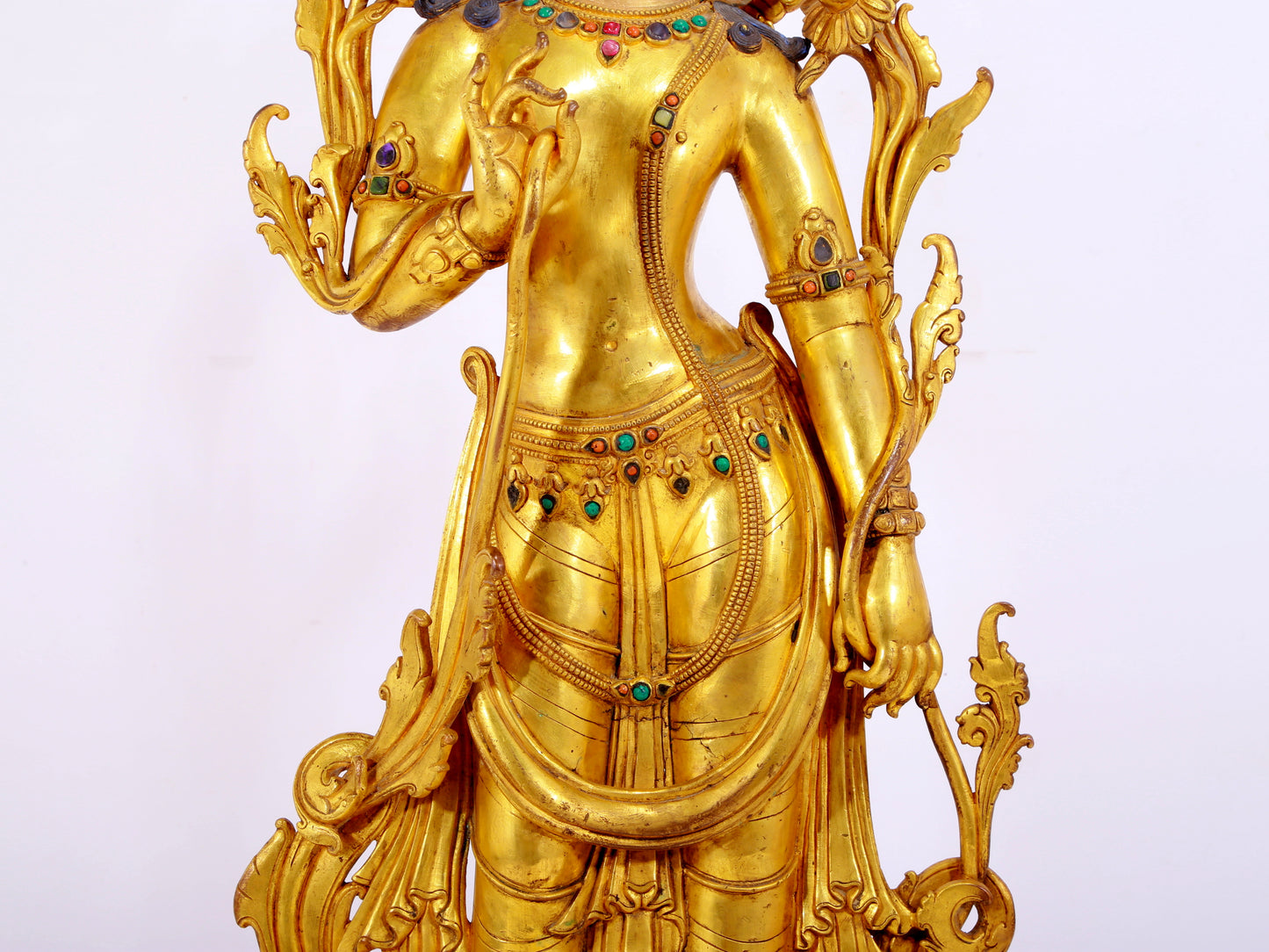 A gilt bronze statue of Tara inlaid with hundreds of treasures