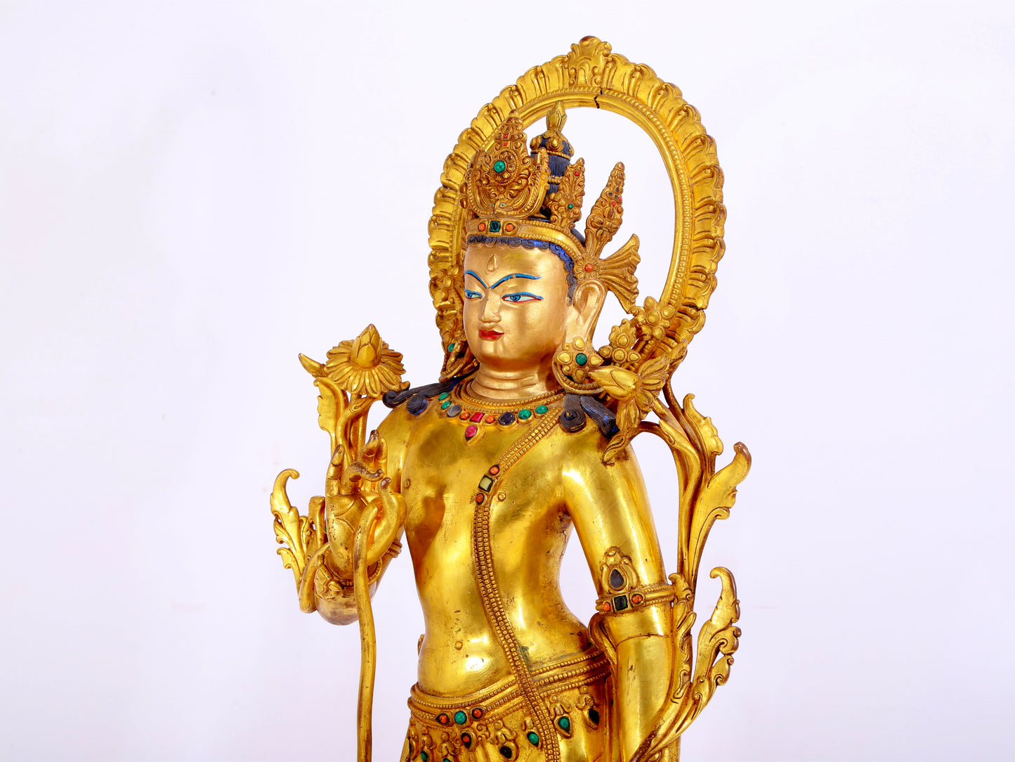 A gilt bronze statue of Tara inlaid with hundreds of treasures