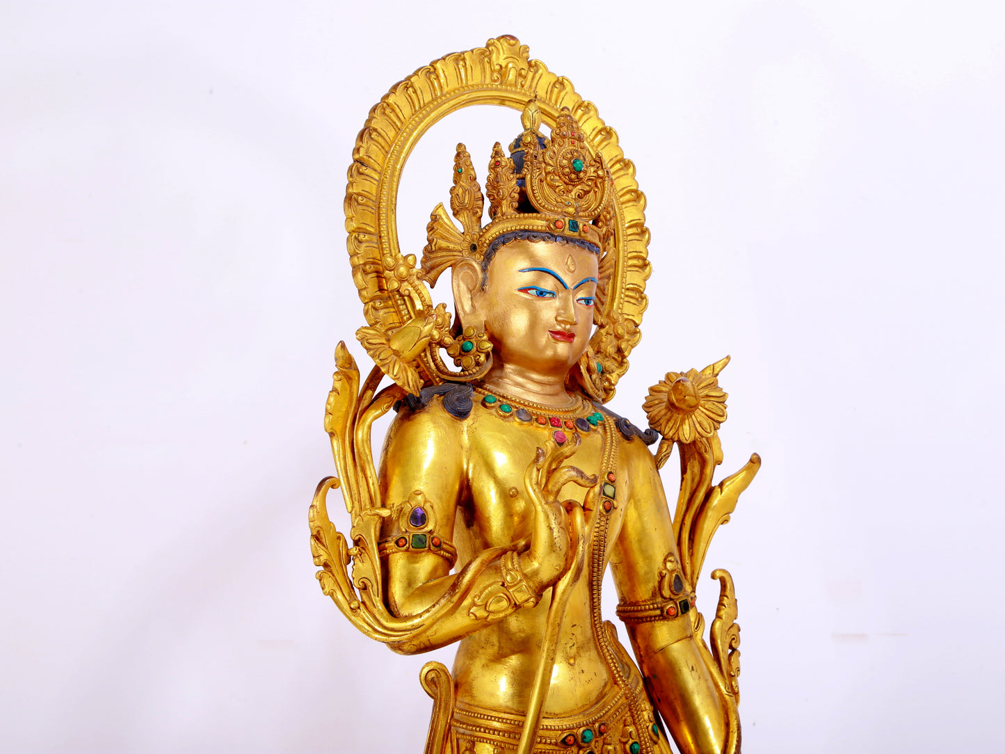 A gilt bronze statue of Tara inlaid with hundreds of treasures