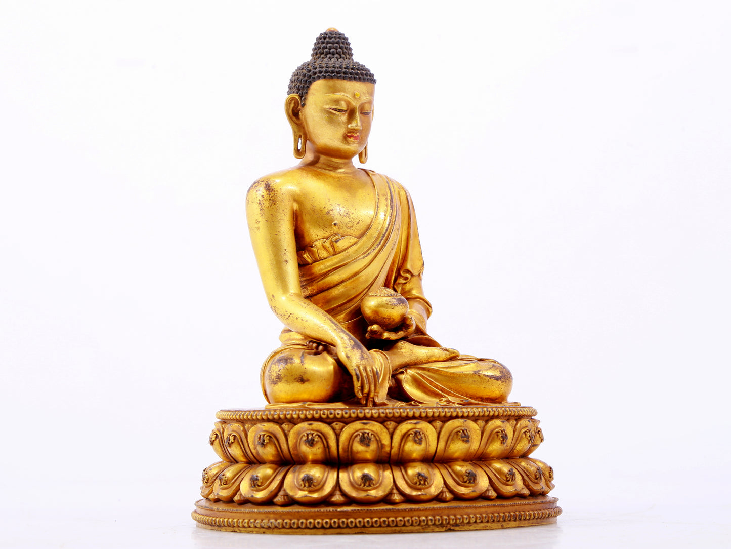 A majestic gilt bronze statue of Sakyamuni