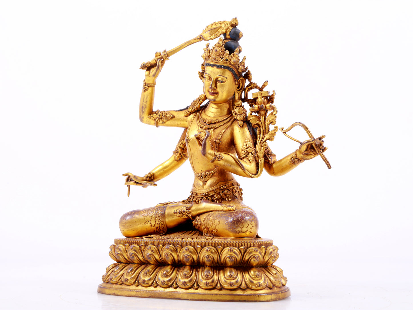 A majestic gilt bronze four-armed Manjushri statue with inscription