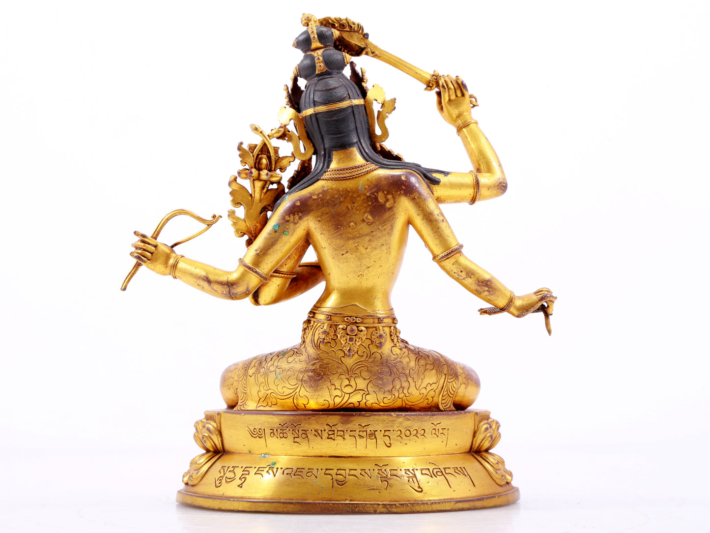 A majestic gilt bronze four-armed Manjushri statue with inscription