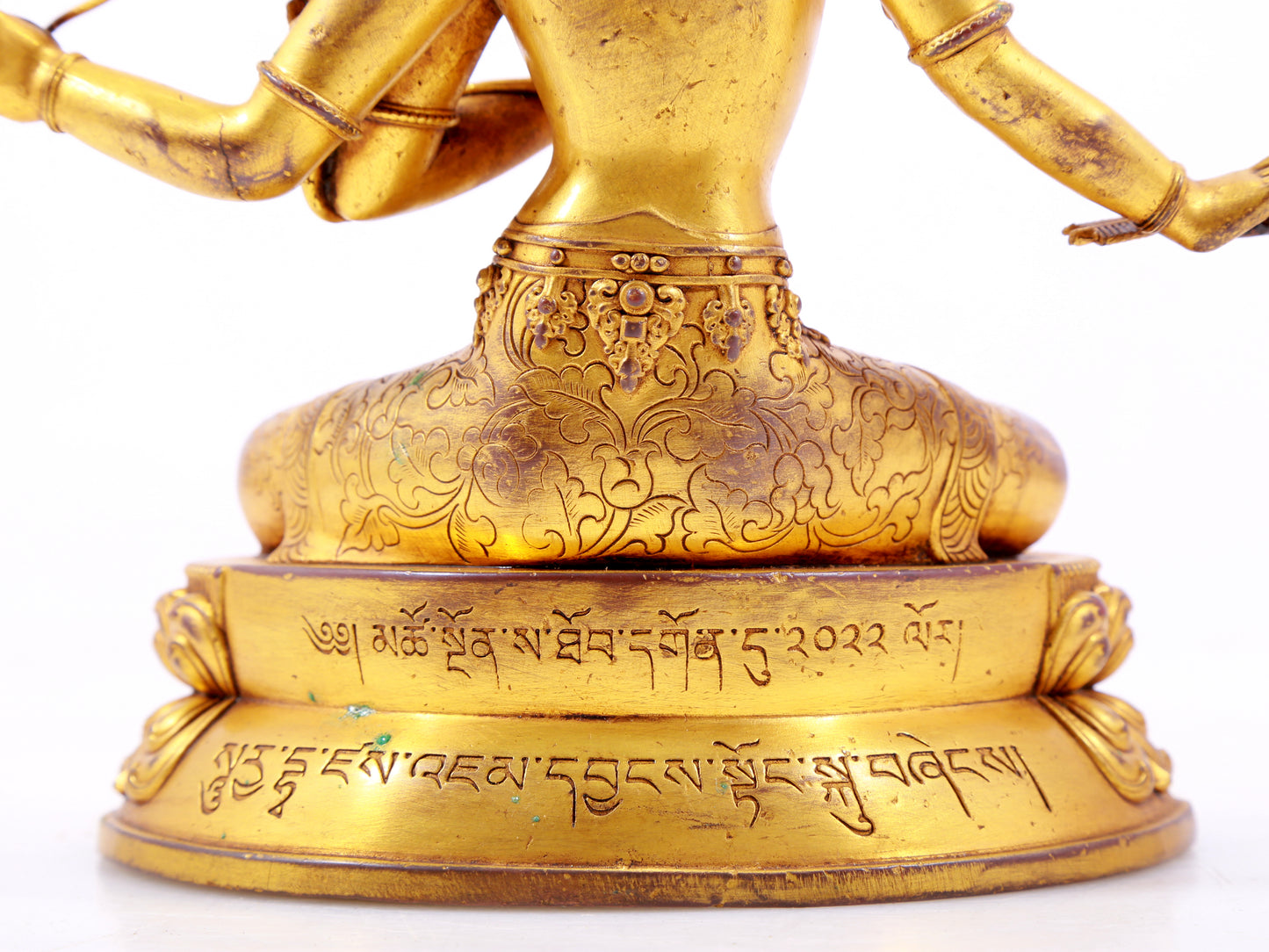 A majestic gilt bronze four-armed Manjushri statue with inscription