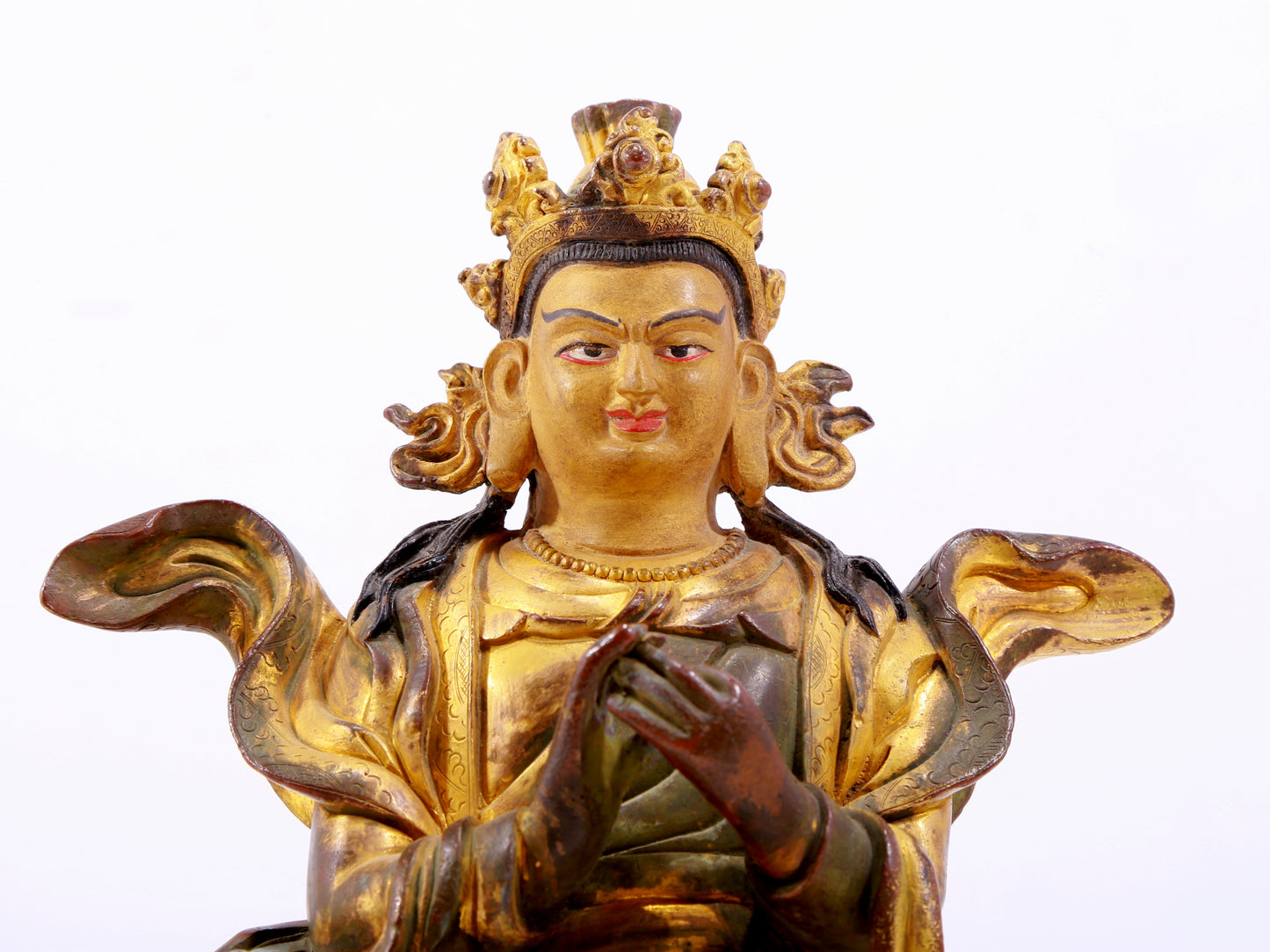 A solemn gilt bronze statue of the Guru