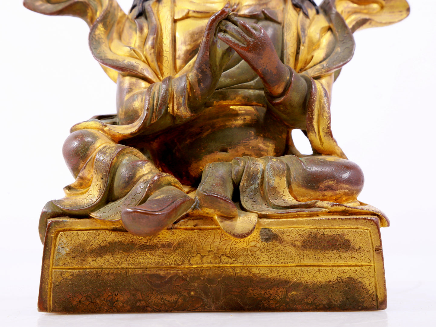 A solemn gilt bronze statue of the Guru