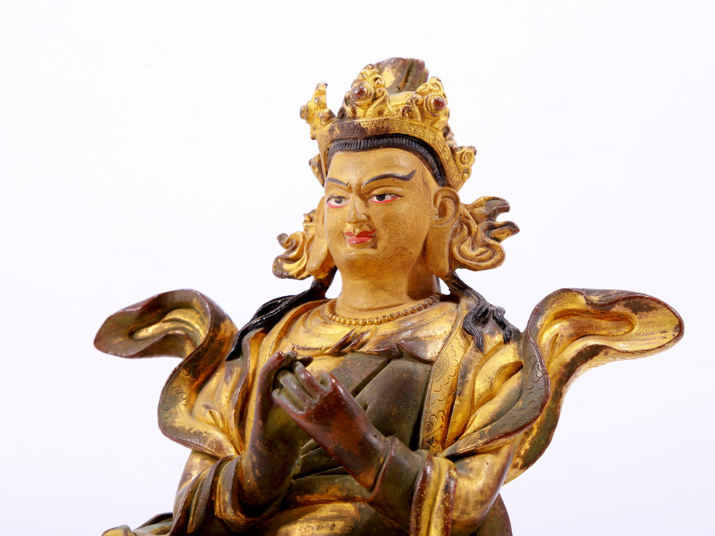 A solemn gilt bronze statue of the Guru