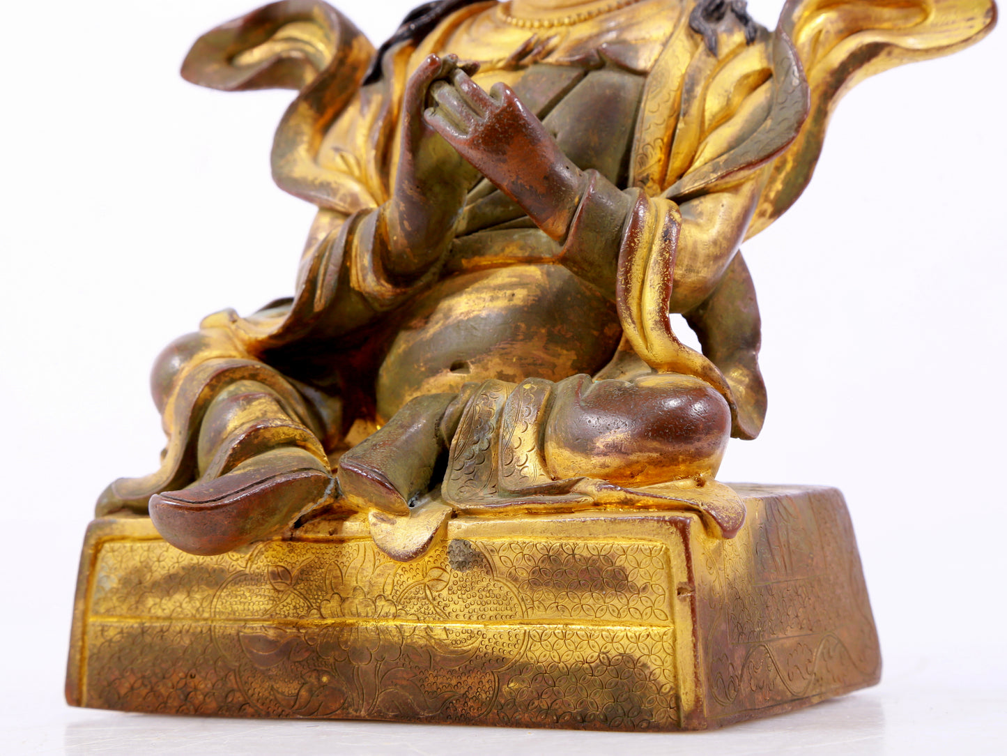 A solemn gilt bronze statue of the Guru