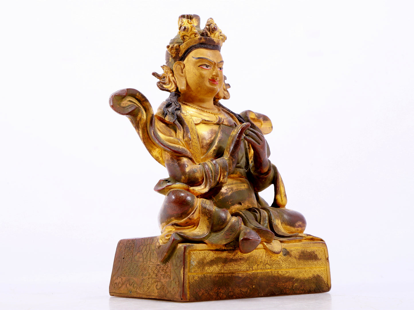 A solemn gilt bronze statue of the Guru