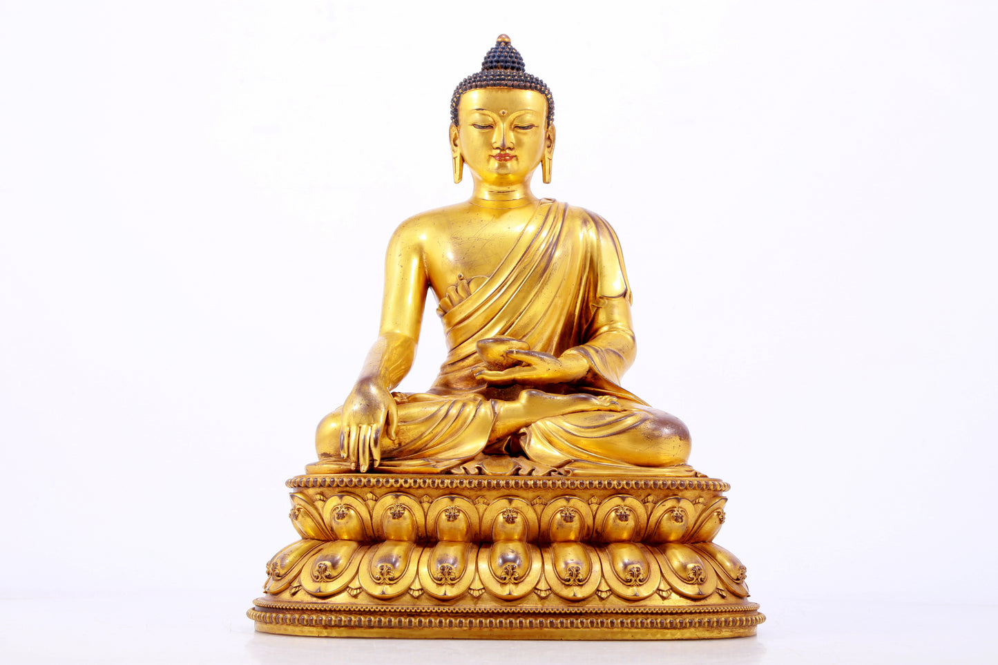 A majestic gilt bronze statue of Sakyamuni