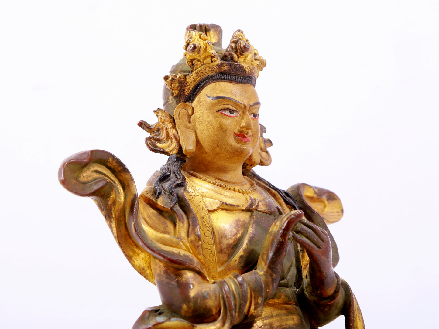 A solemn gilt bronze statue of the Guru