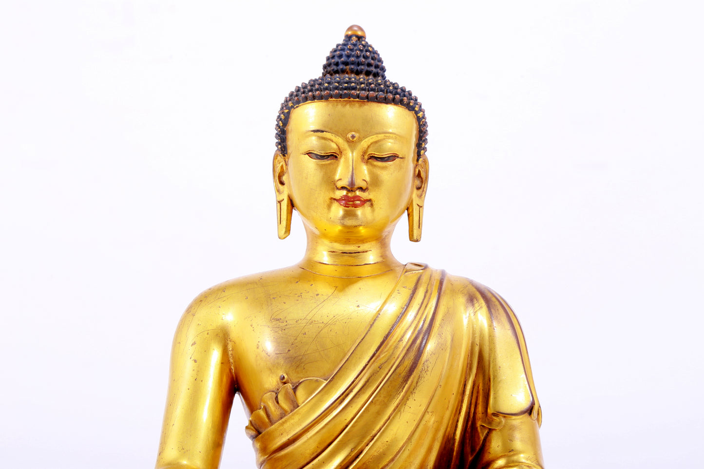 A majestic gilt bronze statue of Sakyamuni