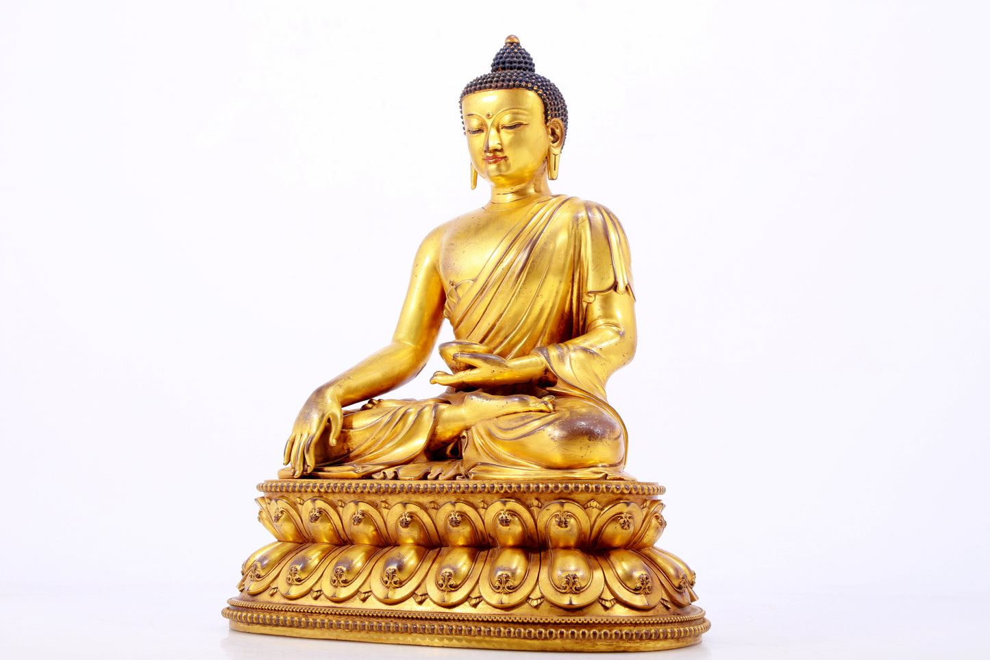 A majestic gilt bronze statue of Sakyamuni