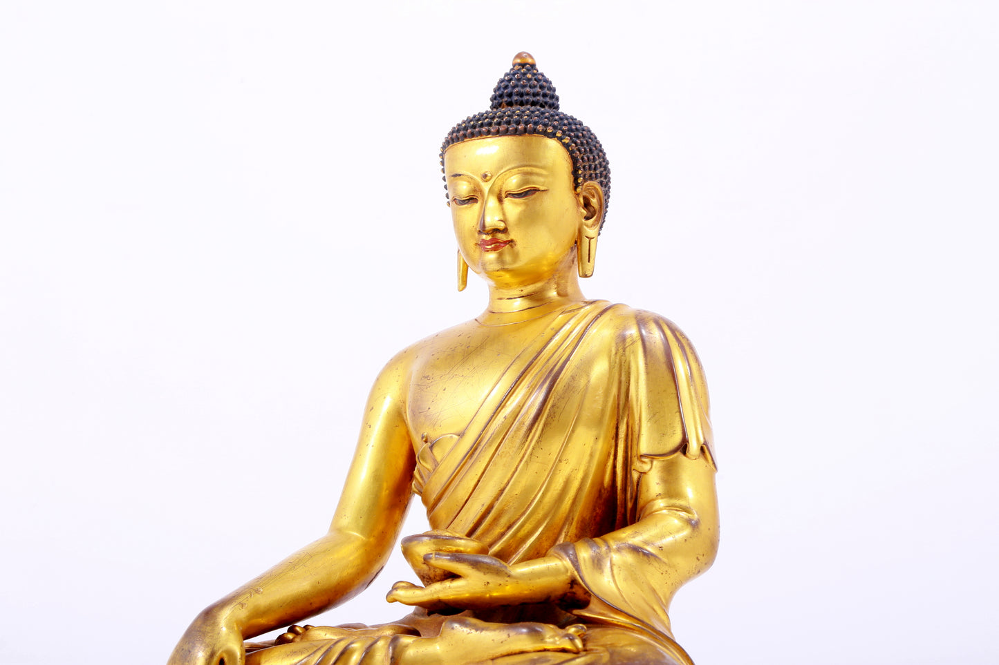 A majestic gilt bronze statue of Sakyamuni