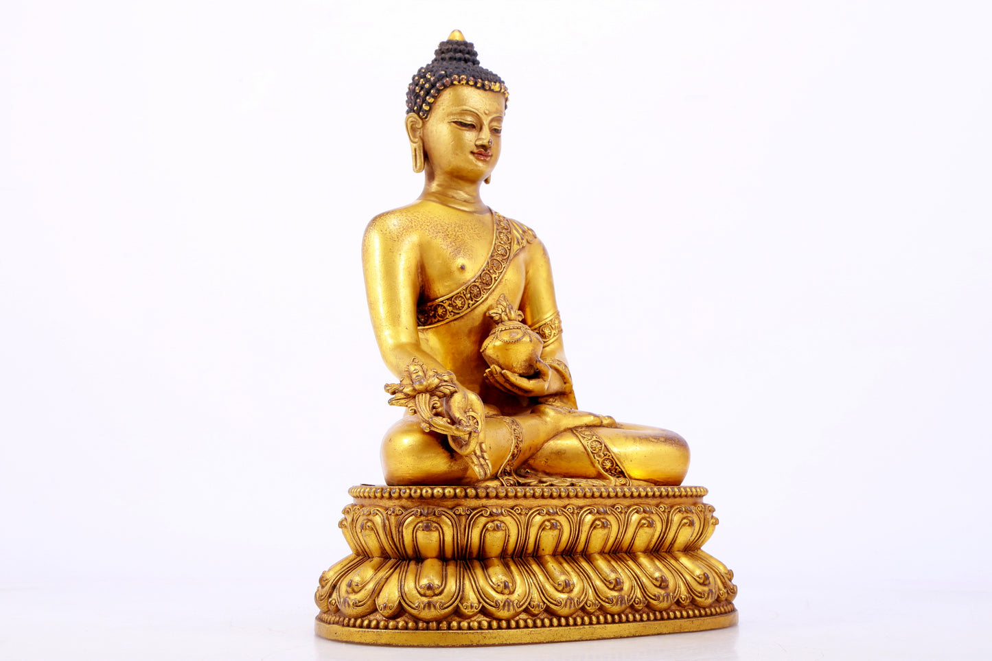 A majestic gilt bronze statue of Sakyamuni