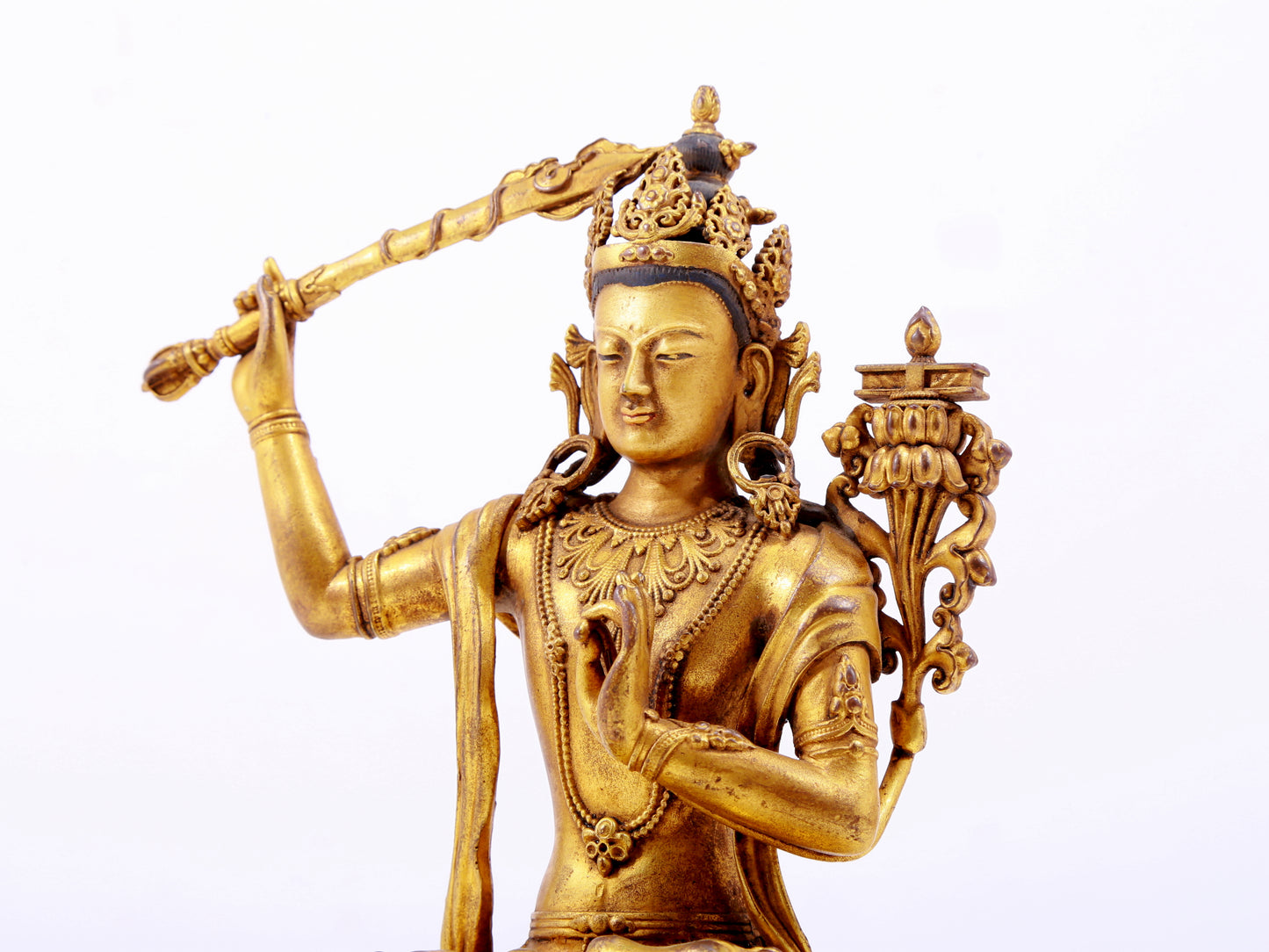 A majestic gilt bronze statue of Manjusri Bodhisattva