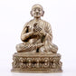 A majestic copper-silvered statue of the Guru