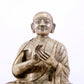 A majestic copper-silvered statue of the Guru