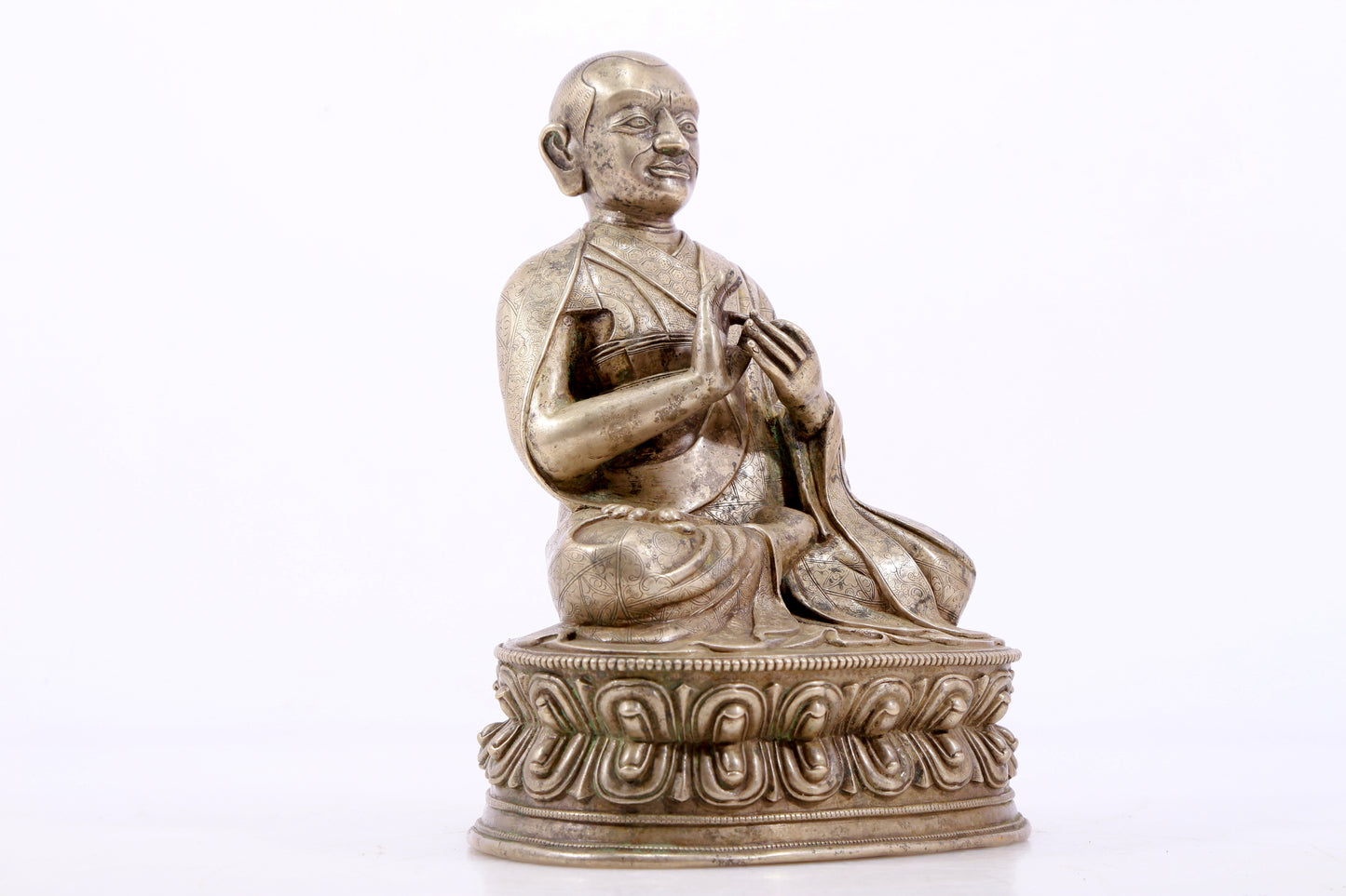 A majestic copper-silvered statue of the Guru