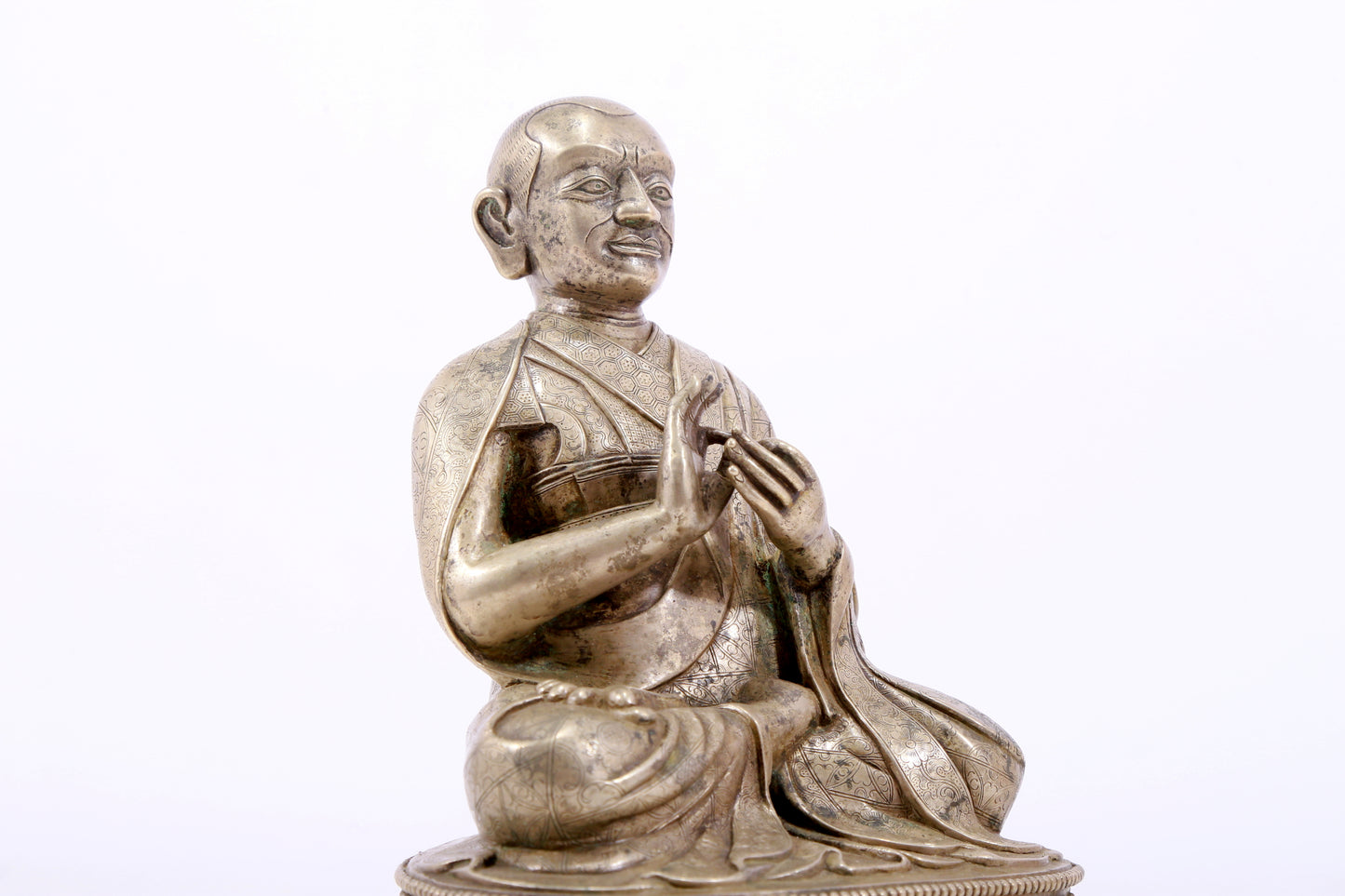 A majestic copper-silvered statue of the Guru