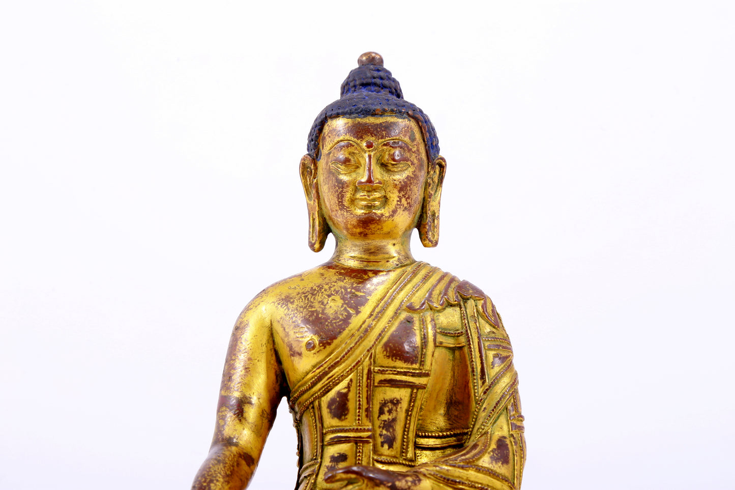 A majestic gilt bronze statue of Sakyamuni