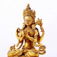 A majestic gilt bronze four-armed Guanyin statue