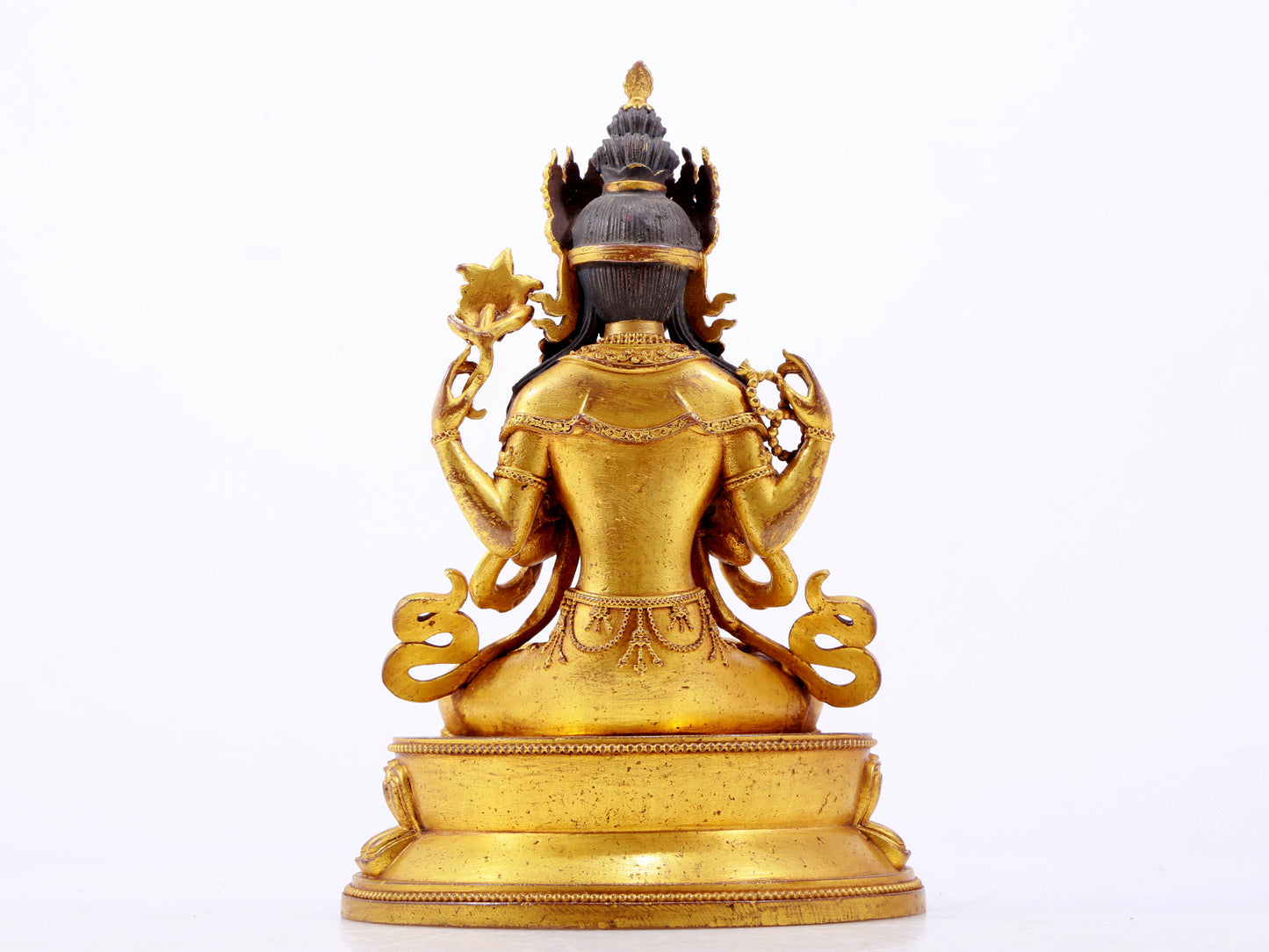 A majestic gilt bronze four-armed Guanyin statue