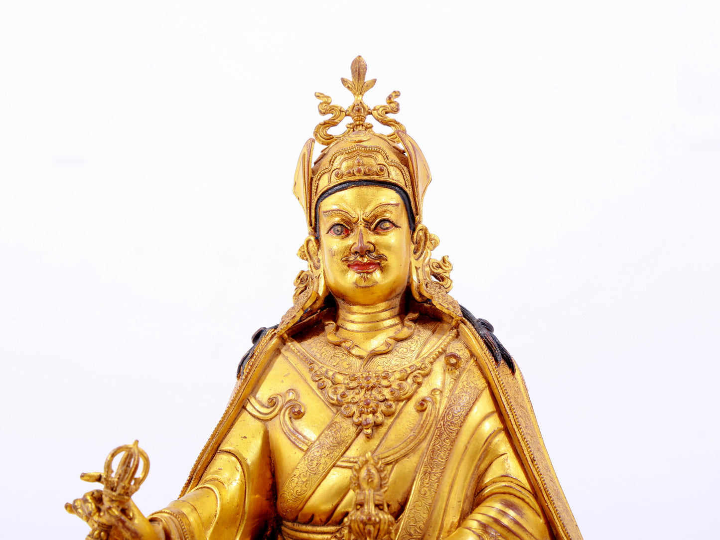 A solemn gilt bronze statue of Padmasambhava