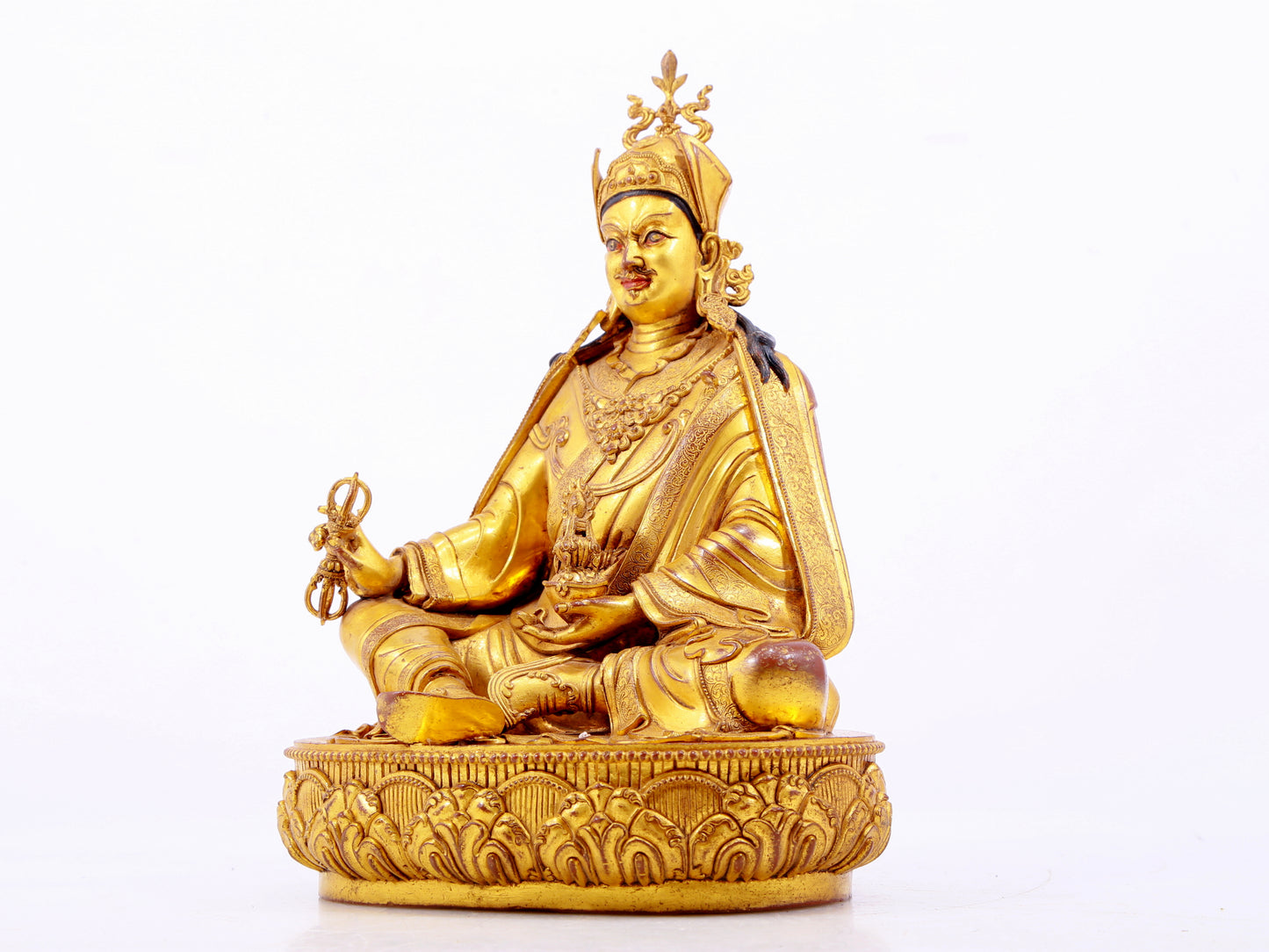 A solemn gilt bronze statue of Padmasambhava