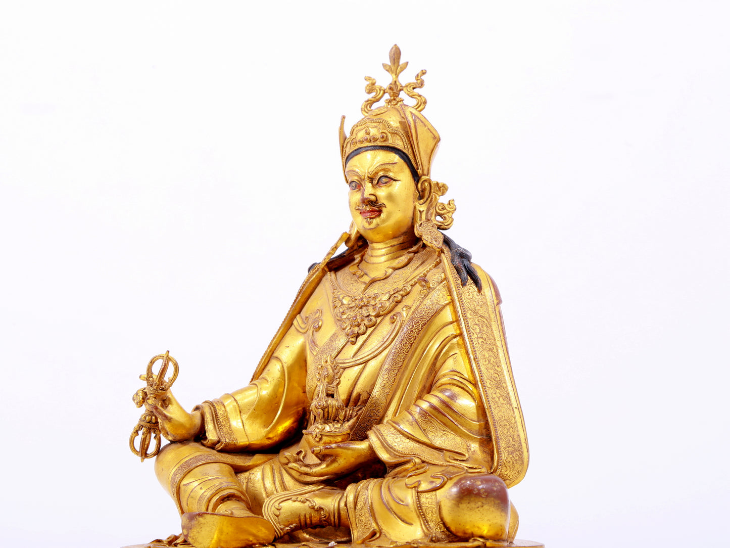 A solemn gilt bronze statue of Padmasambhava