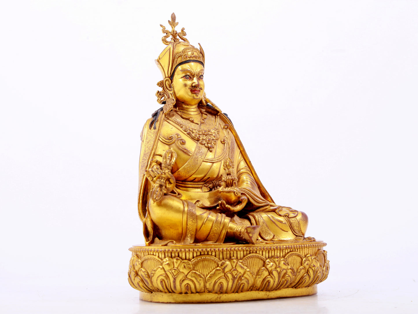 A solemn gilt bronze statue of Padmasambhava