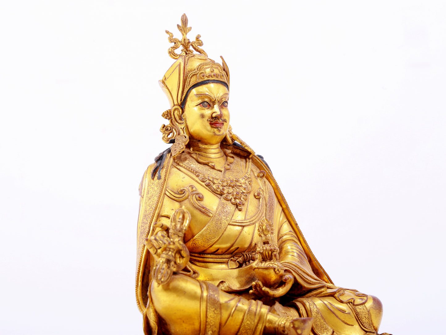 A solemn gilt bronze statue of Padmasambhava