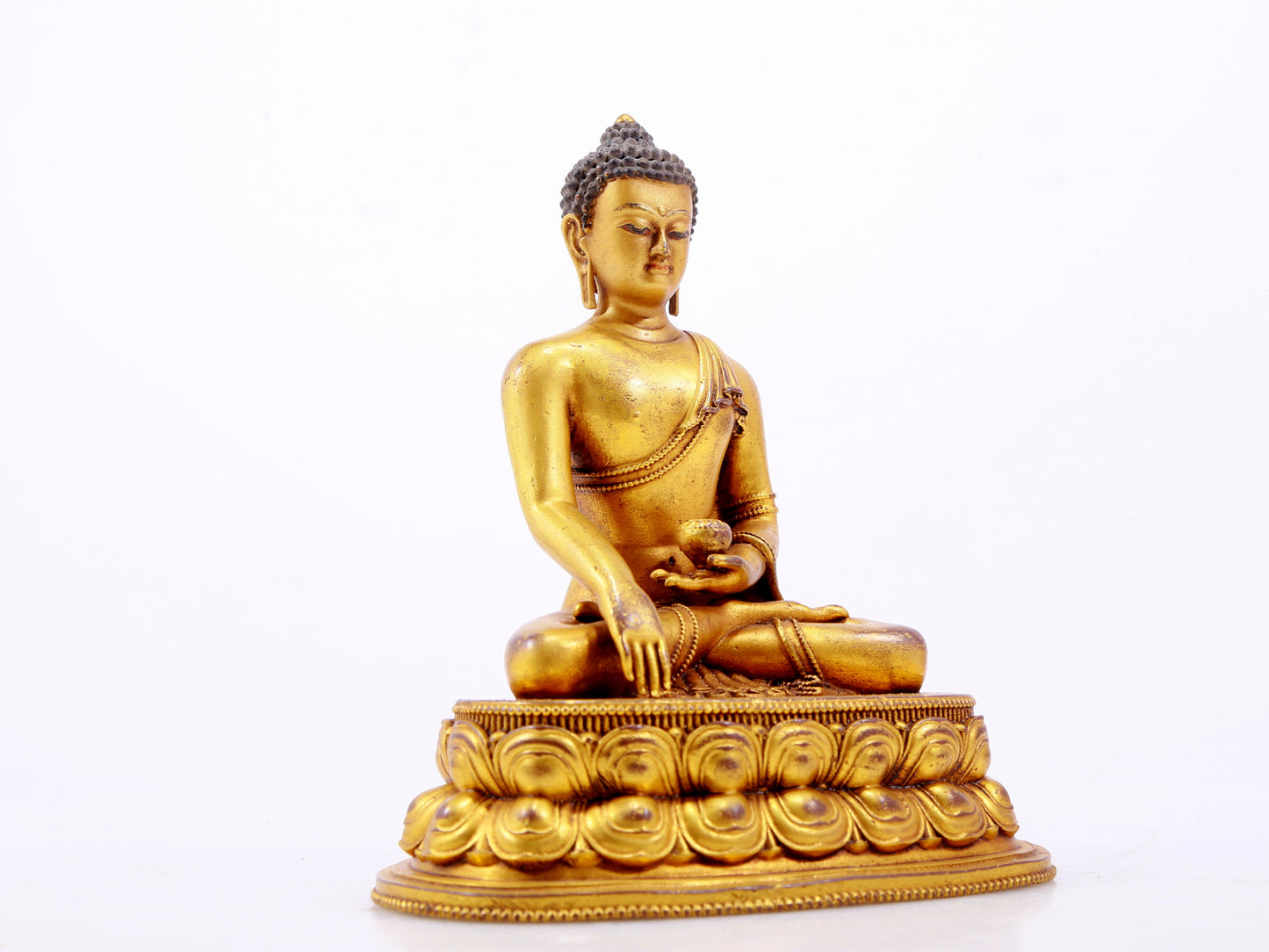 A majestic gilt bronze statue of Sakyamuni