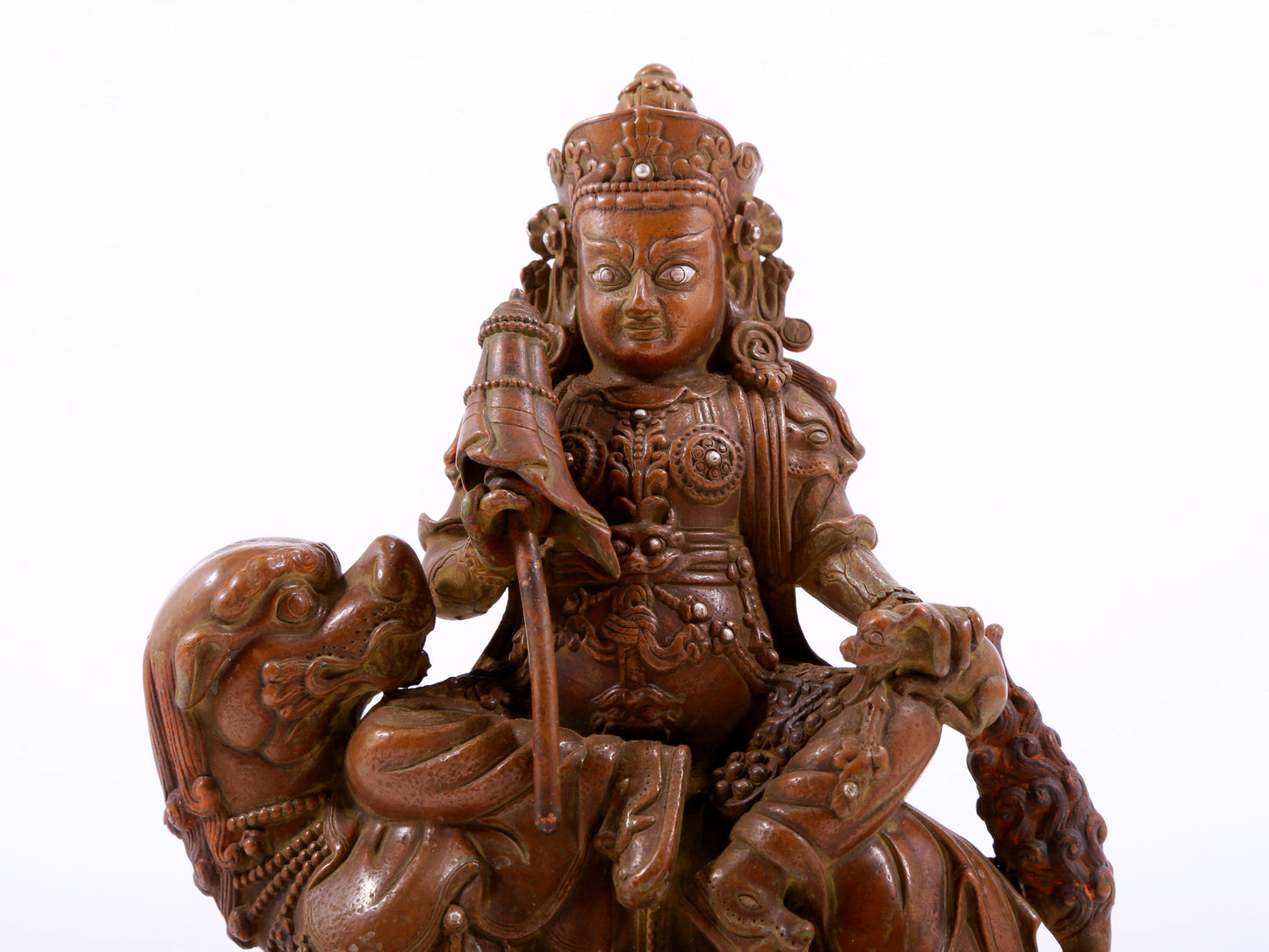 A solemn alloy copper inlaid silver statue of the God of Wealth riding a lion