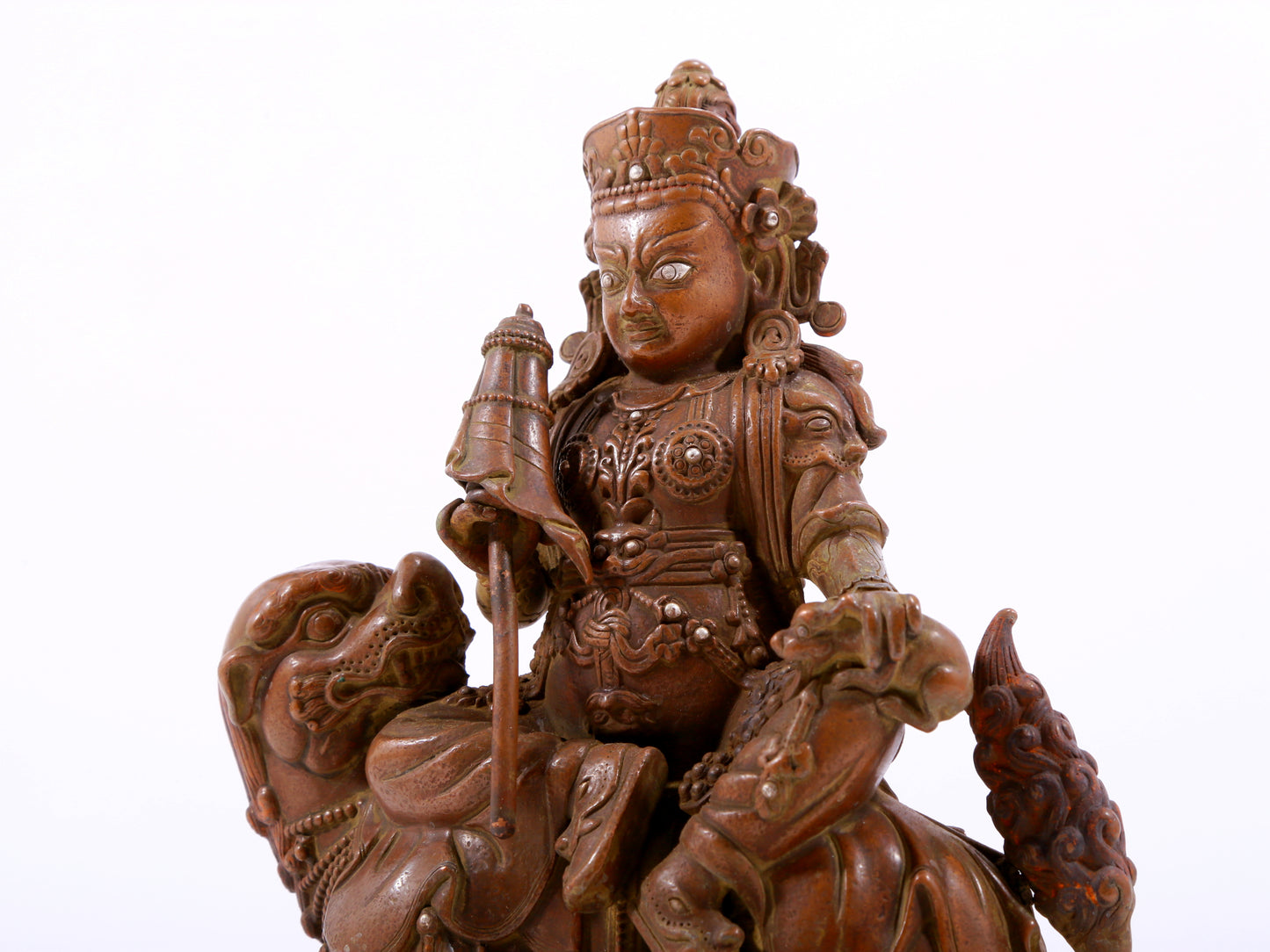 A solemn alloy copper inlaid silver statue of the God of Wealth riding a lion