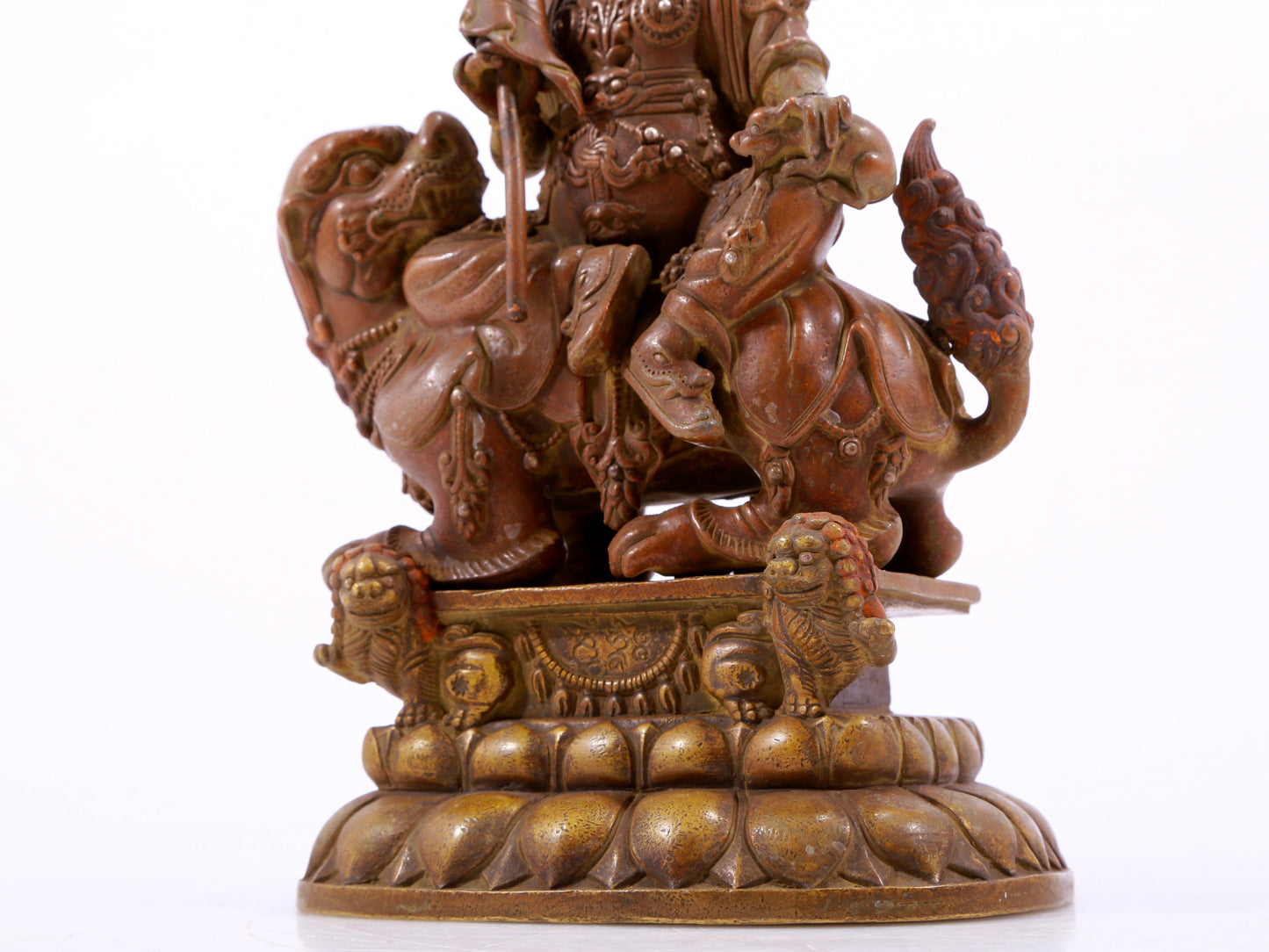 A solemn alloy copper inlaid silver statue of the God of Wealth riding a lion