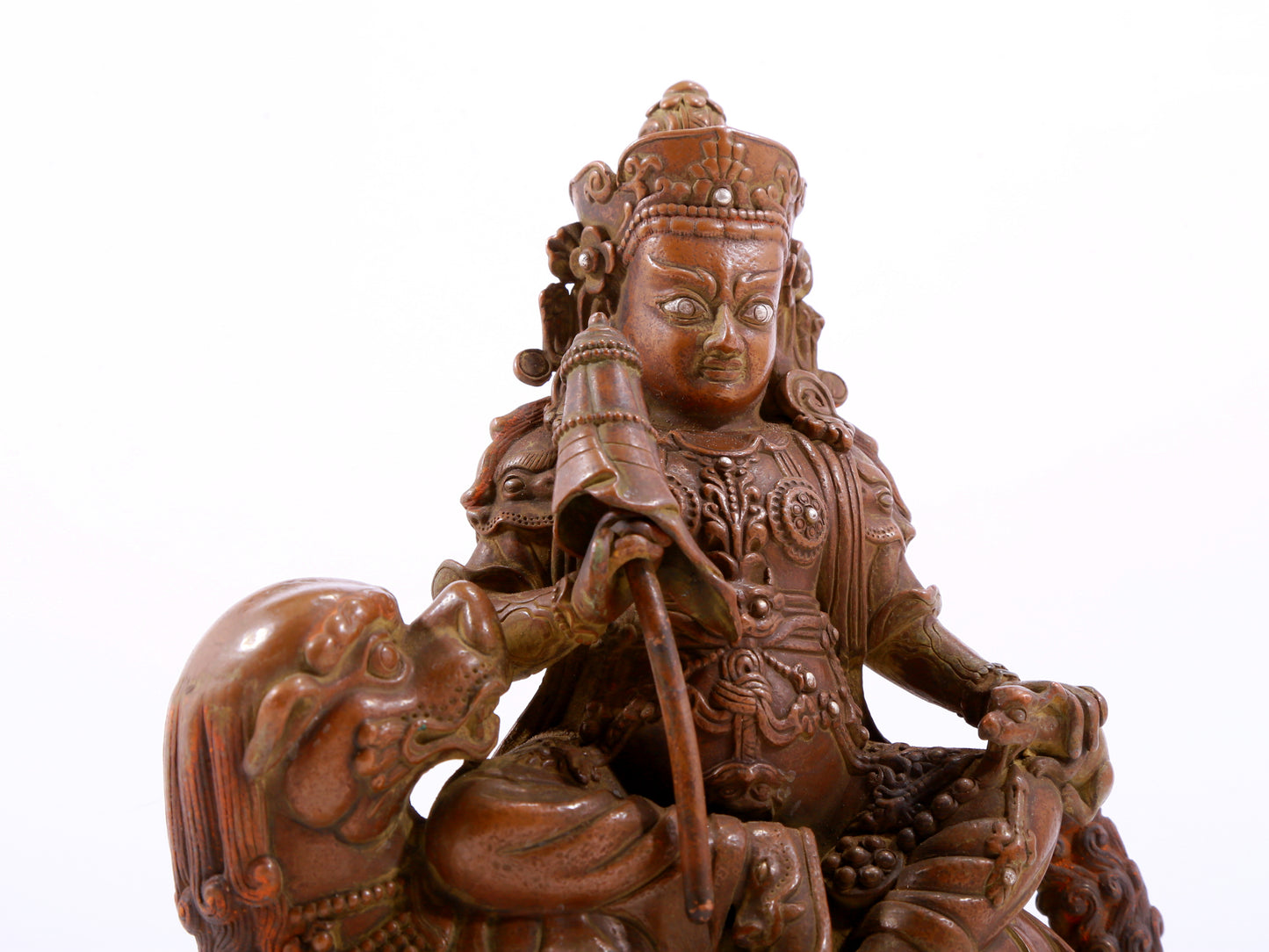 A solemn alloy copper inlaid silver statue of the God of Wealth riding a lion