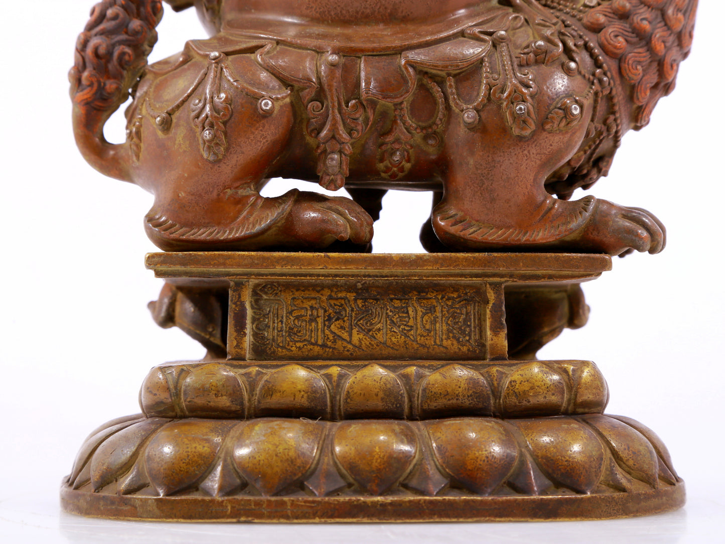 A solemn alloy copper inlaid silver statue of the God of Wealth riding a lion